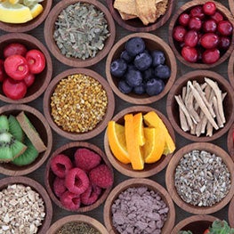 A collection of brown bowls with different fruits and ingredients
